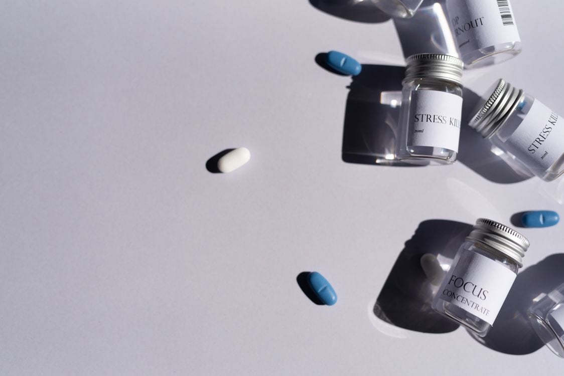 Prescription medicine bottles and pills on a clean white background